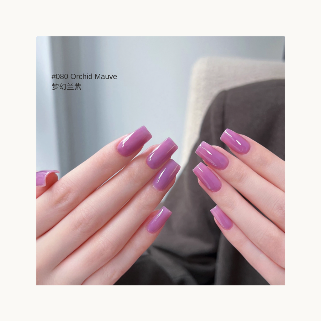 Close-up of long square gel nails in a glossy orchid mauve color, showcasing a smooth and vibrant purple-pink finish.