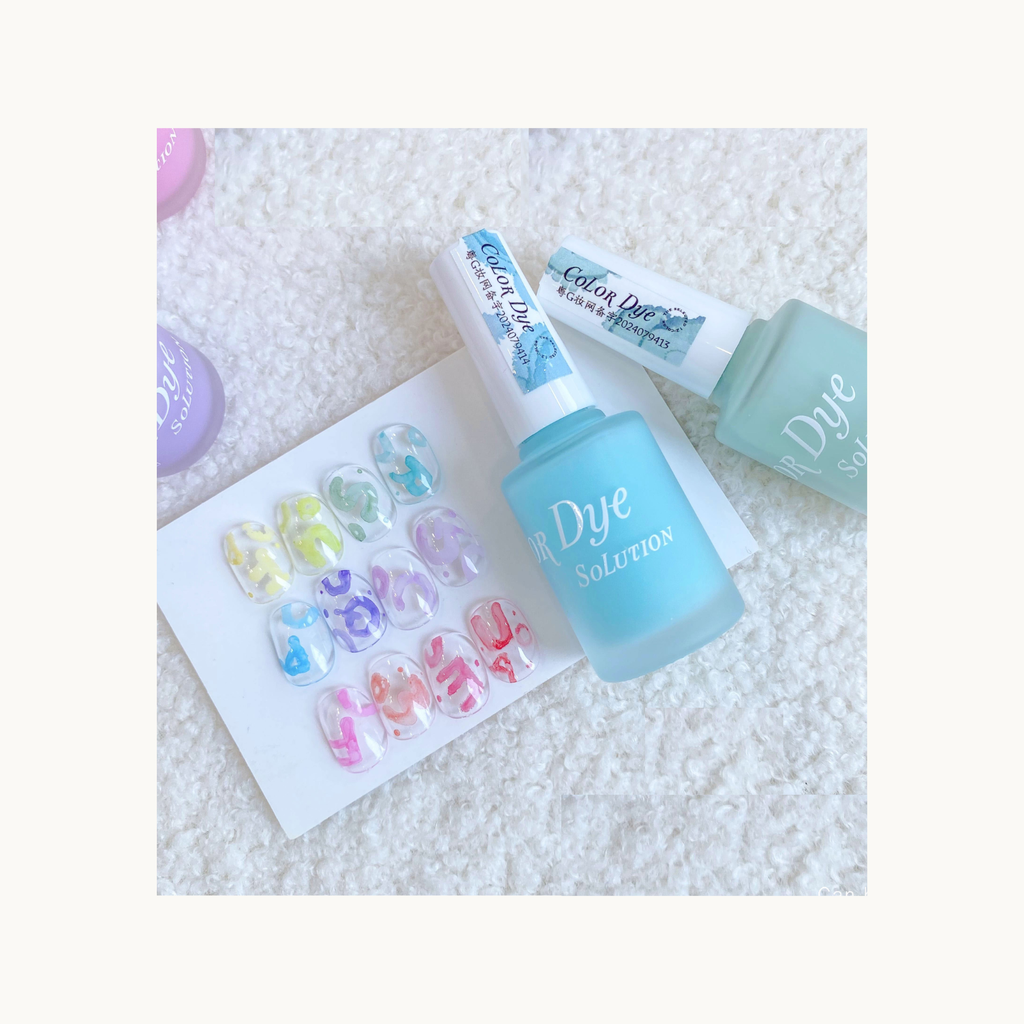 pastel 12-color watercolor nail dye gel swatches displayed on a board with checker nail tips above