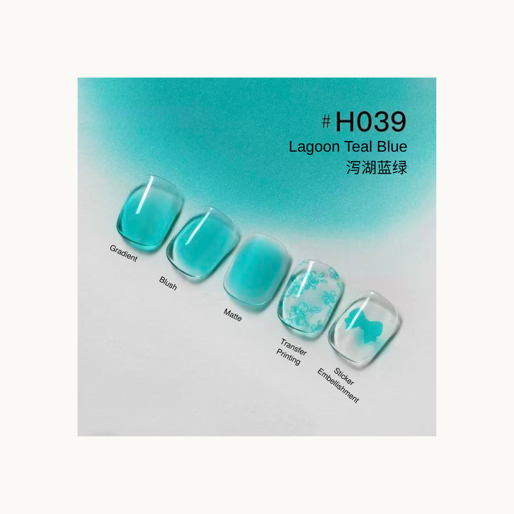 Teal blue press-on nails with lagoon-inspired gradient, blush, matte finish, and floral transfer prints.