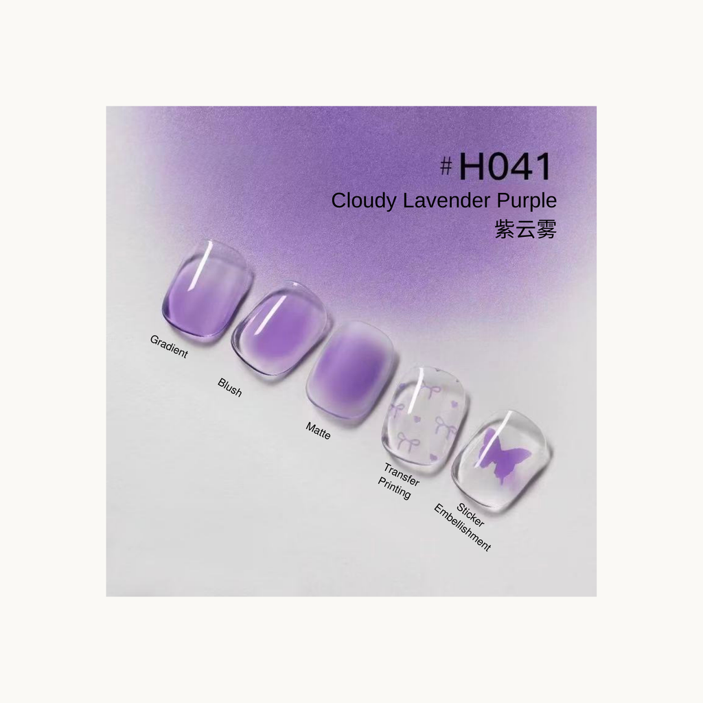 Taye Nformula Life cloudy lavender purple press-on nails with gradient, blush, matte finish, and butterfly transfer accents.