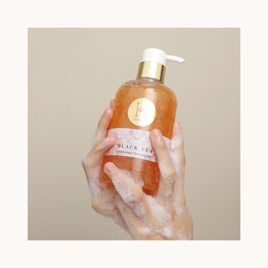 Hands lathering HIGHS Black Tea Exfoliating Cleansing Gel with rich foam, exfoliating hand wash and body cleanser