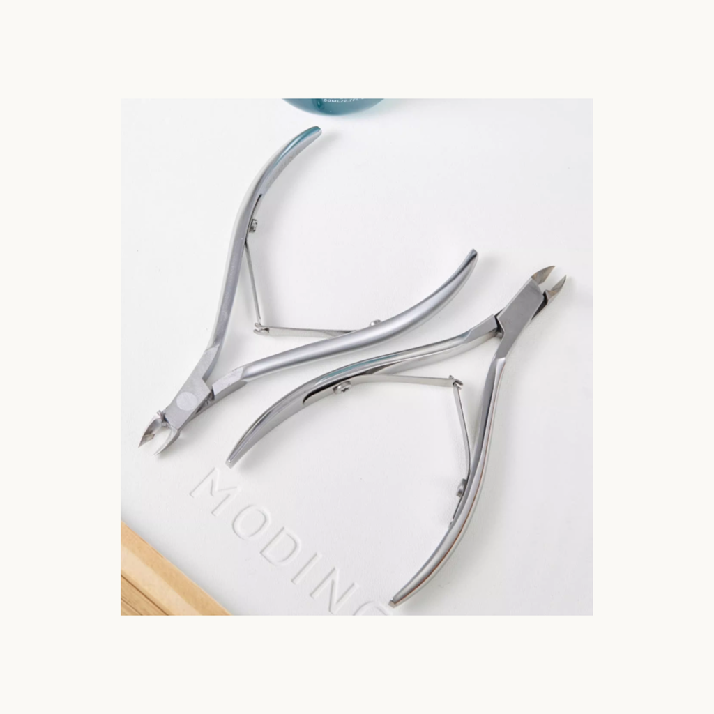 Two MODING stainless steel cuticle nippers displayed together for professional manicure use