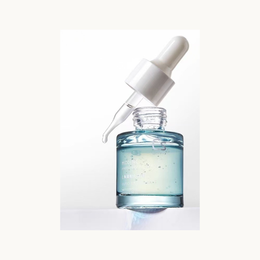 MODING clear cuticle softener liquid spilled texture showing lightweight gel formula for nail prep