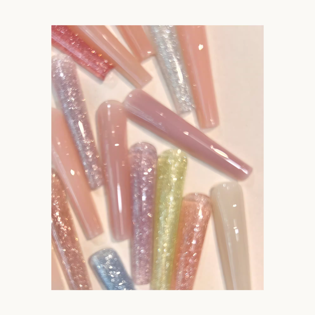 Close-up view of MODING colored extension gel sample nail tips in nude and glitter shades, showcasing transparency, shine, and extension effects.