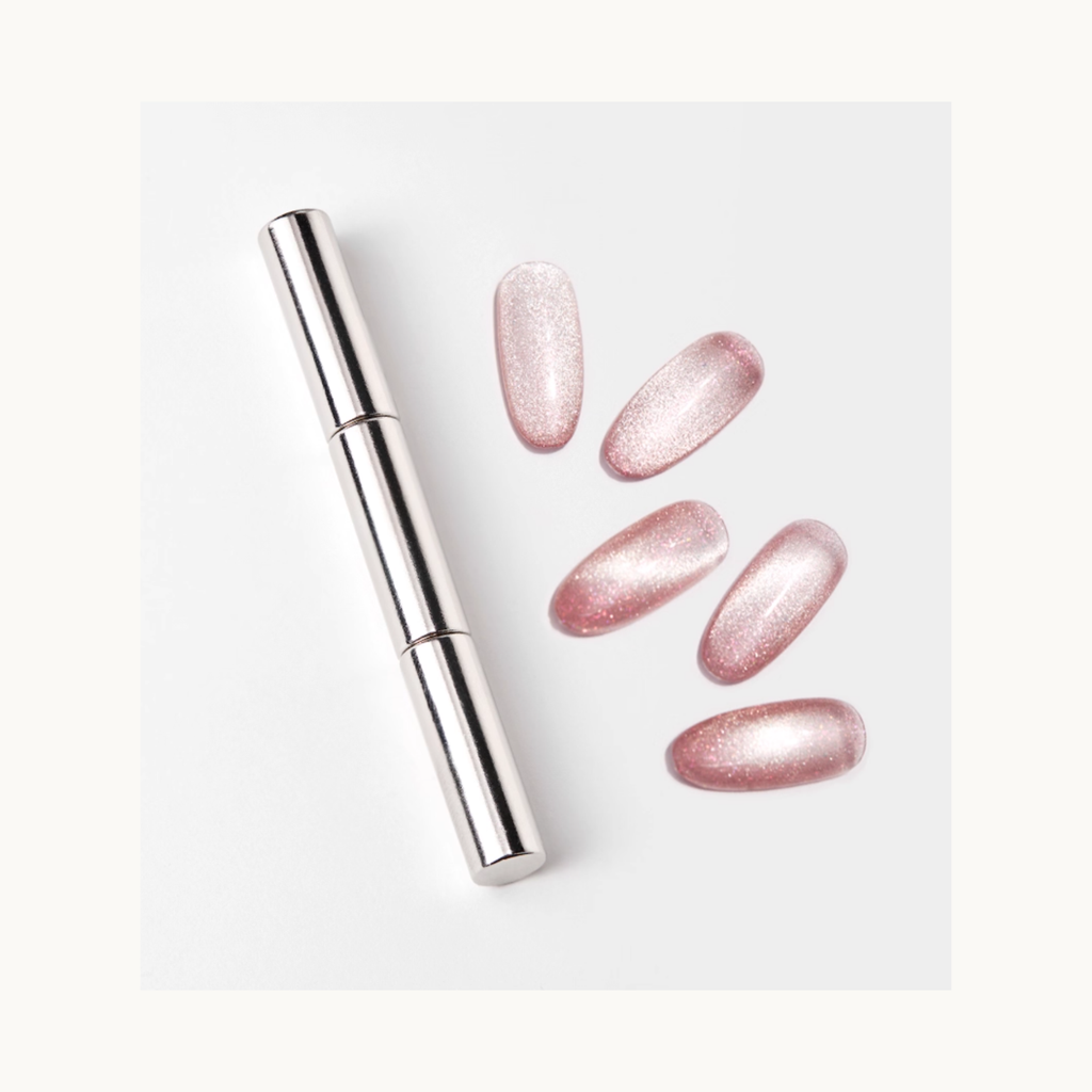 Silver magnetic cat-eye wand displayed beside multiple pink shimmering cat-eye nail samples.