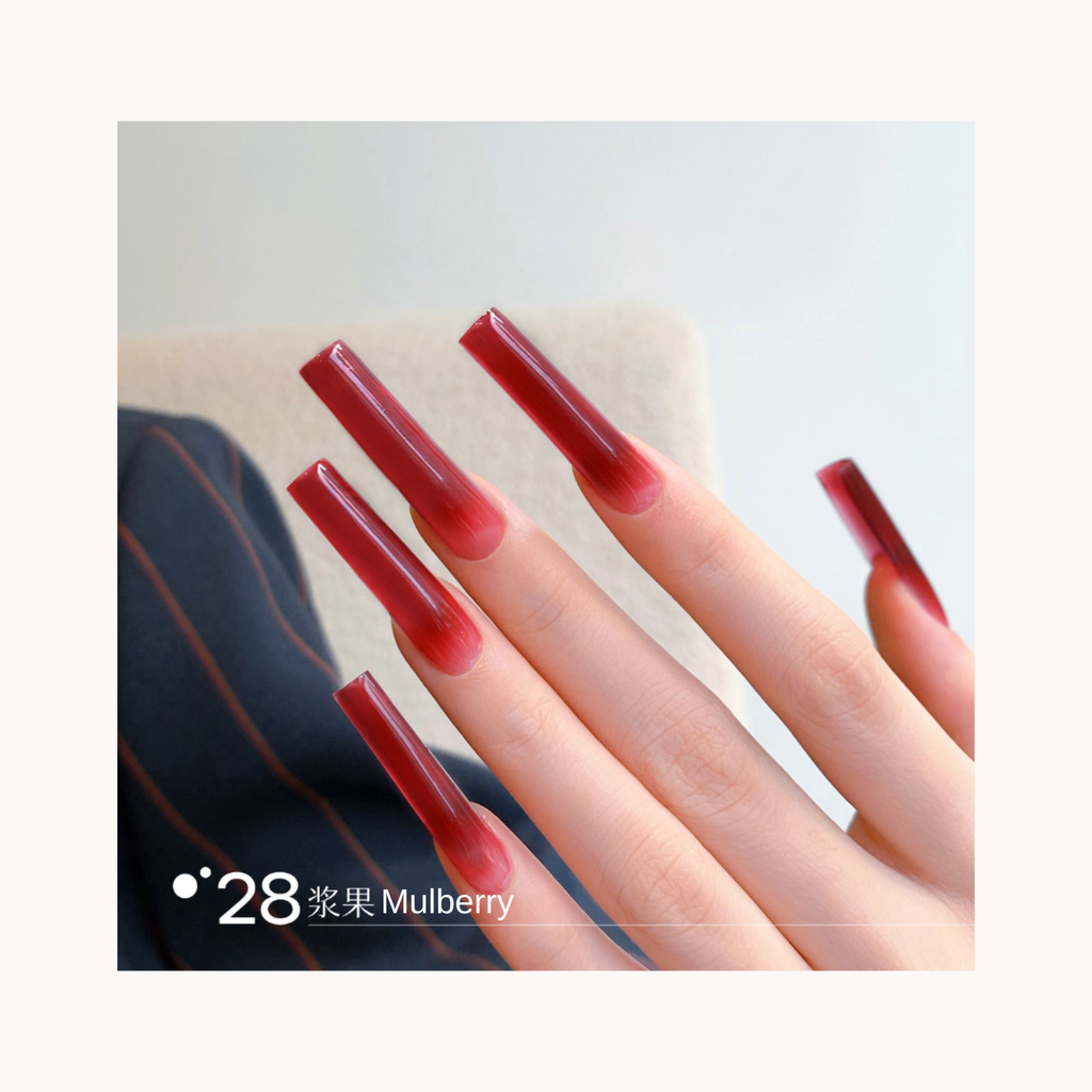 Long coffin-shaped nails painted in shade Q28 Mulberry, a deep berry-red gradient with a rich glossy shine.
