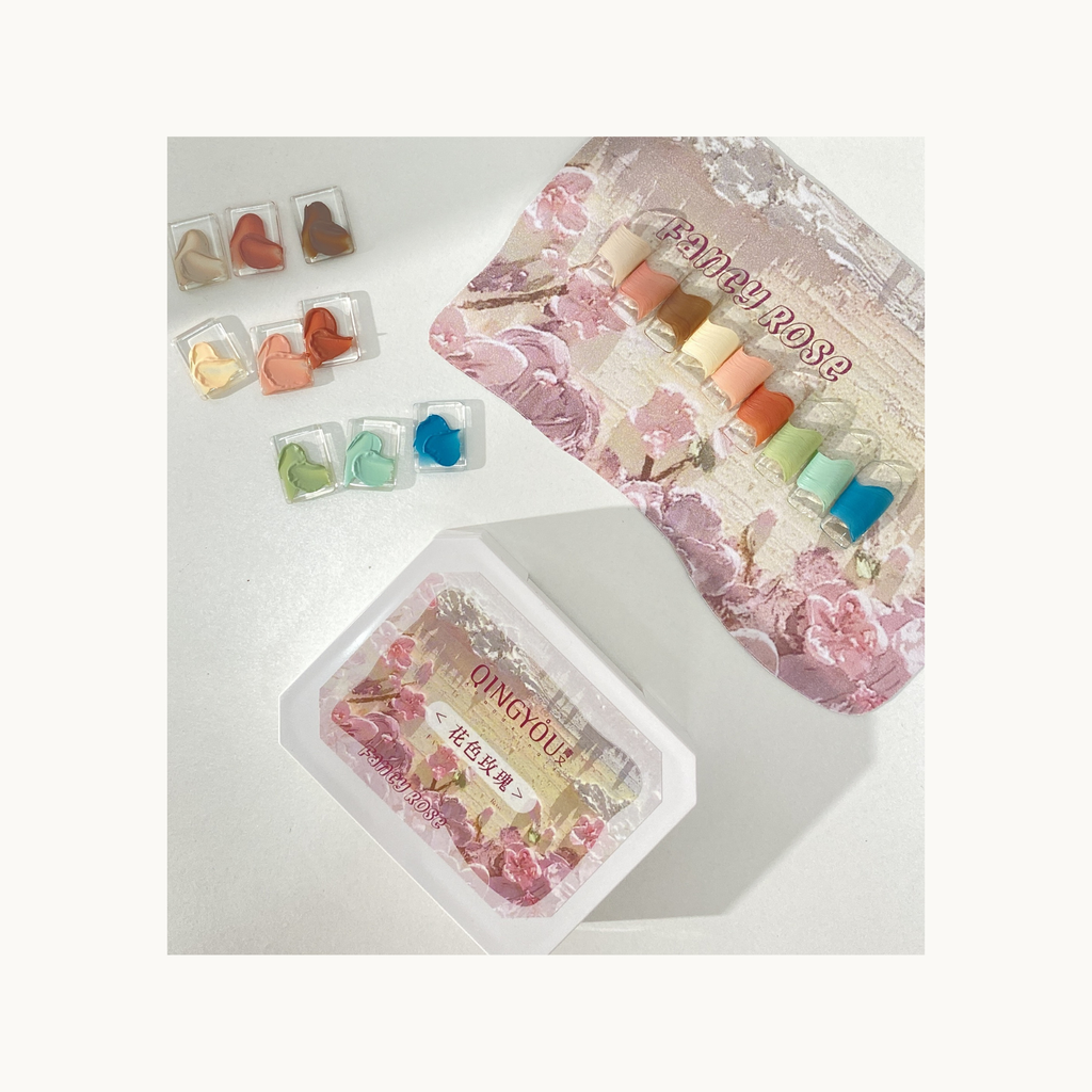 Solid color nail swatches in rose-inspired tones displayed beside the QINGYOU Fancy Rose gel palette