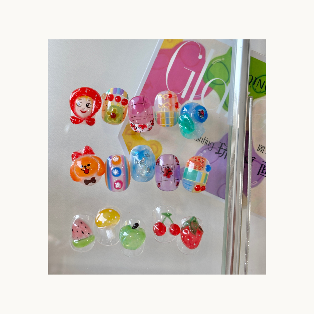 Colorful jelly-glass painting gel nail designs featuring cartoon characters and fruit motifs from QINGYOU Glass Jelly Palette
