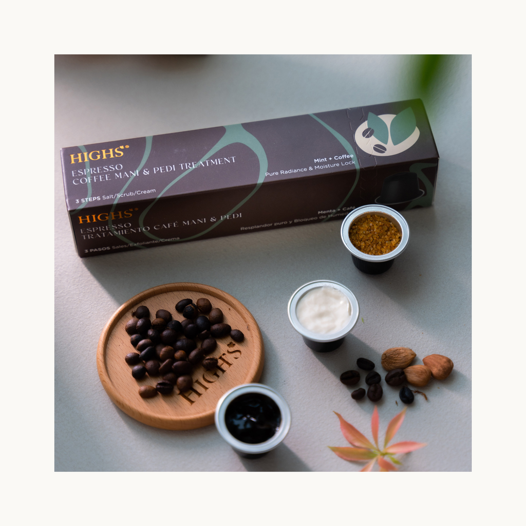 Flatlay of HIGHS Mint + Coffee Espresso hand and foot care set, including soak, scrub, and cream capsules with coffee beans and spa ingredients.