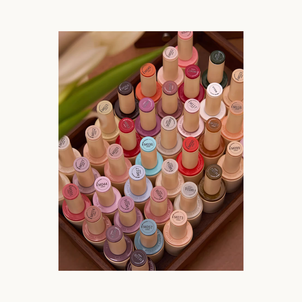 Top view of MODING 128 Colors Gel Polish bottles showing labeled color caps inside wooden tray