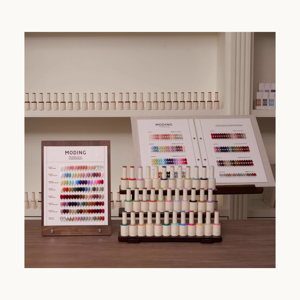 MODING 128 Colors Gel Polish Set displayed on salon counter with color charts and bottle racks