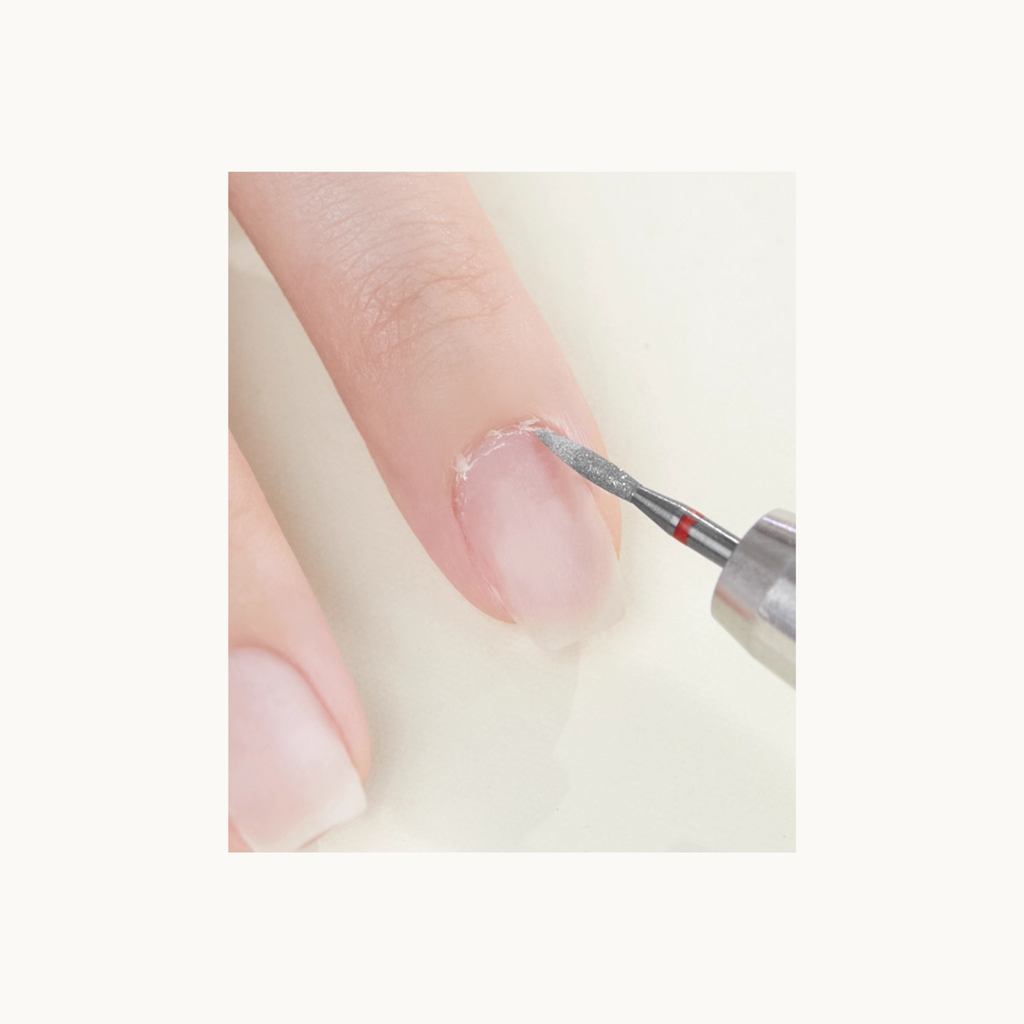 Applying MODING prep liquid to soften dead skin for gentle exfoliation during nail prep