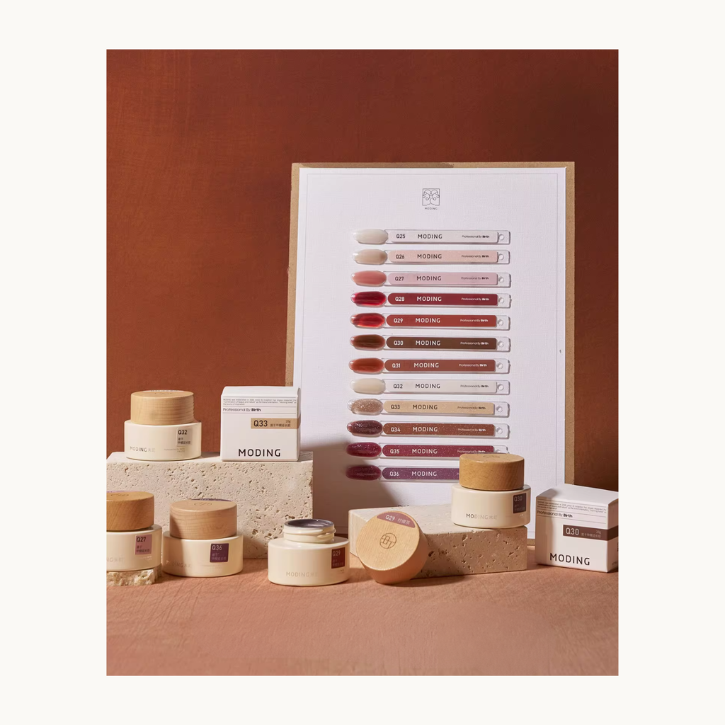 Professional product display of MODING Quick Builder Gel Amber Glow Series, featuring 12 shades with color swatch board, extension molds, and packaging.