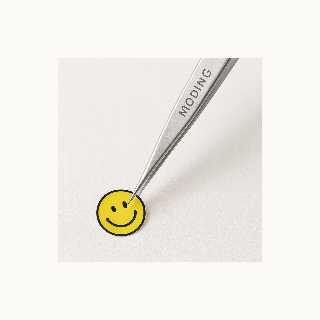 MODING TZ01 precision tweezers peeling a small smiley sticker for nail art application