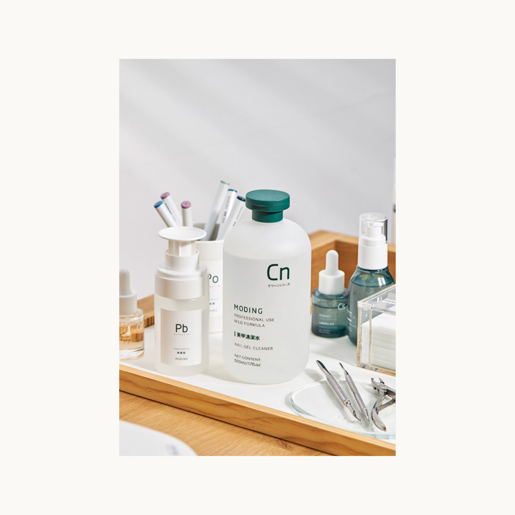 MODING 500ml nail cleanser placed on a manicure workstation with other nail prep products