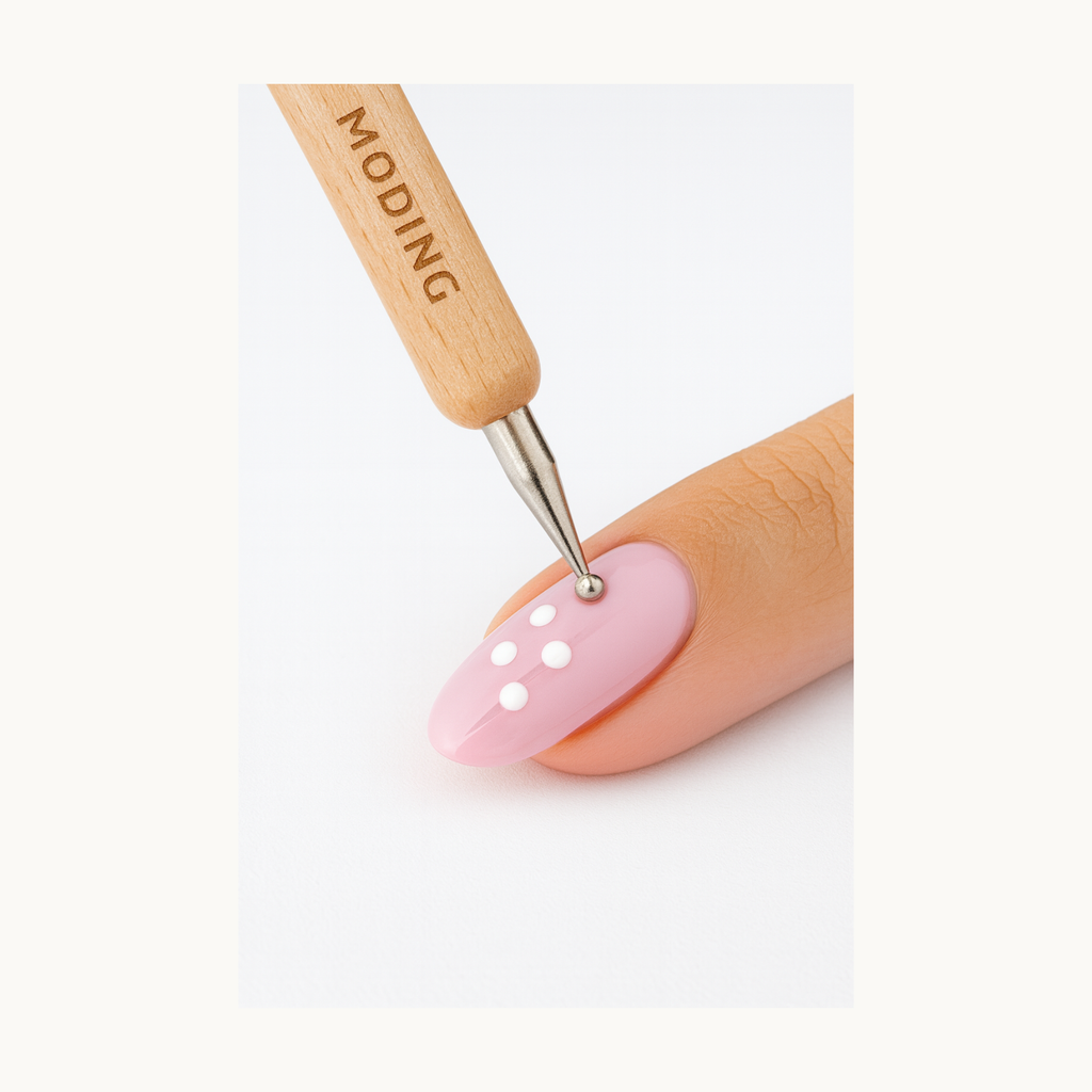 MODING dotting tool applying white gel dots on pink manicure for nail art demonstration
