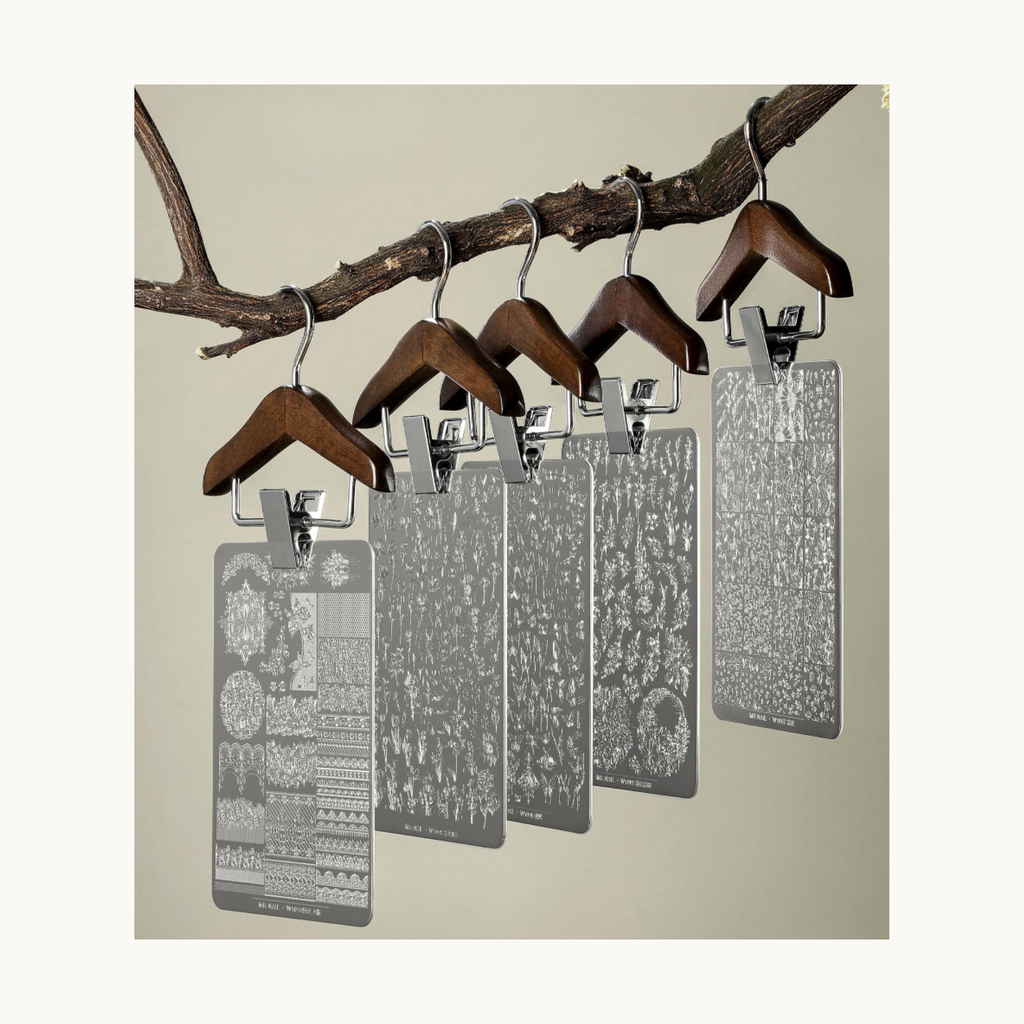 Collection of Mr Nail stamping plates hanging for display, showcasing multiple floral and pattern designs