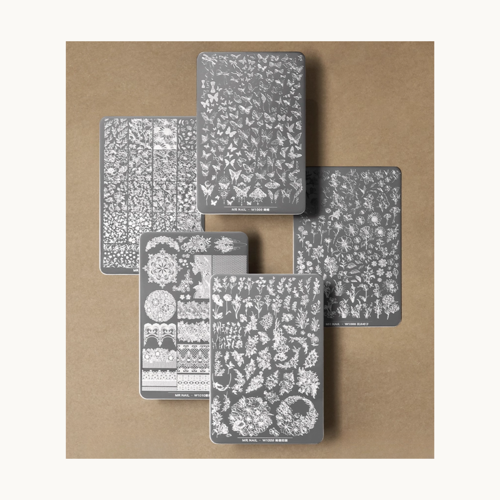 Flatlay of Mr Nail stamping plate series plate with multiple engraved designs