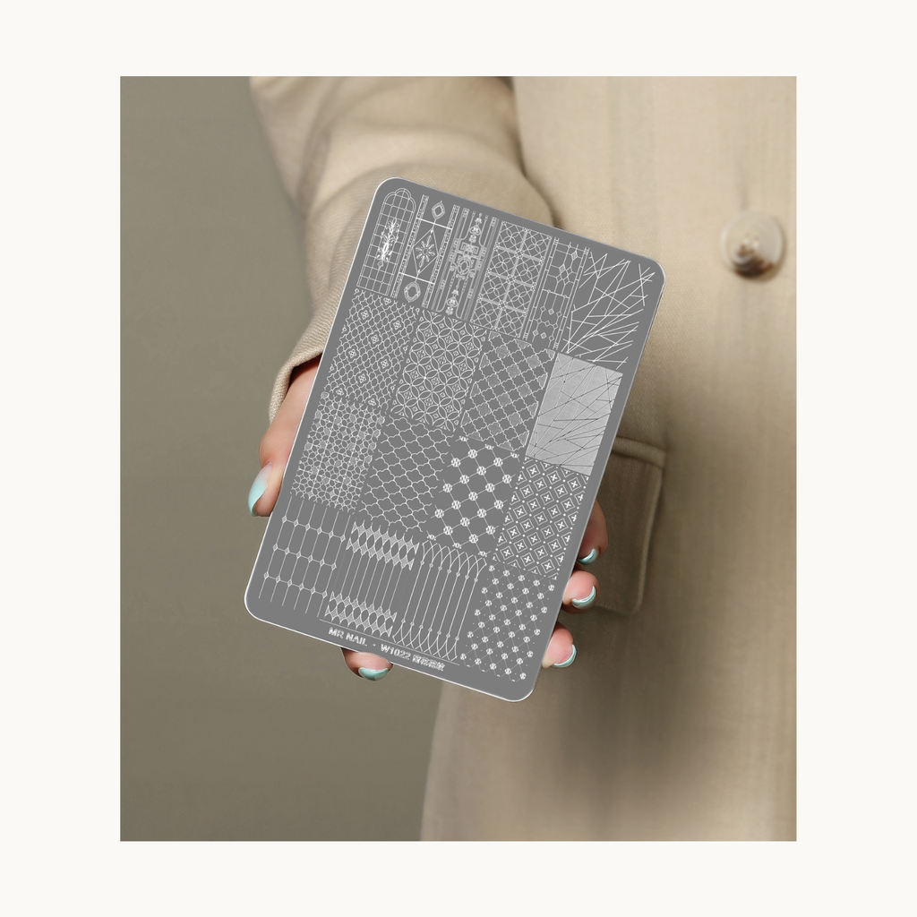 Hand holding MR NAIL W1022 geometric nail stamping plate showcasing detailed pattern engravings