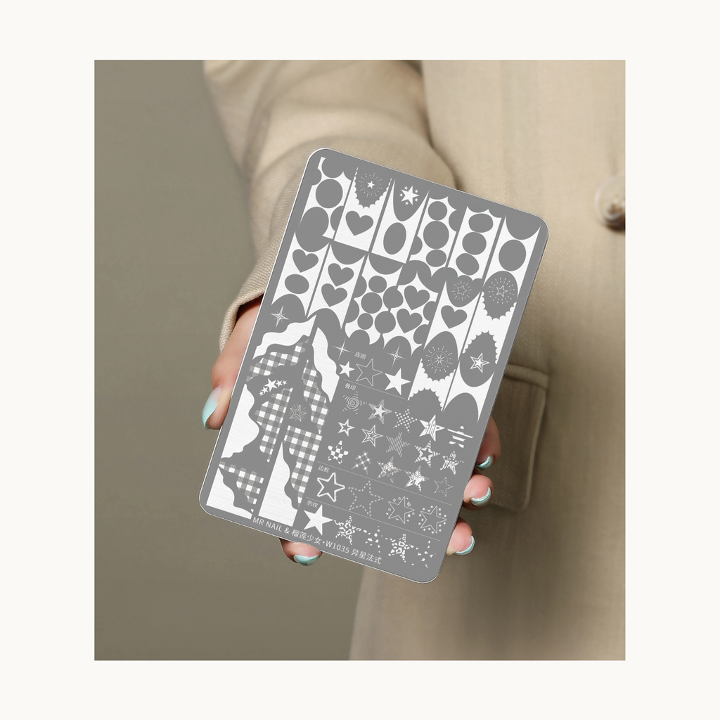Hand holding MR NAIL W1035 Alien French nail stamping plate showcasing star and cosmic French patterns