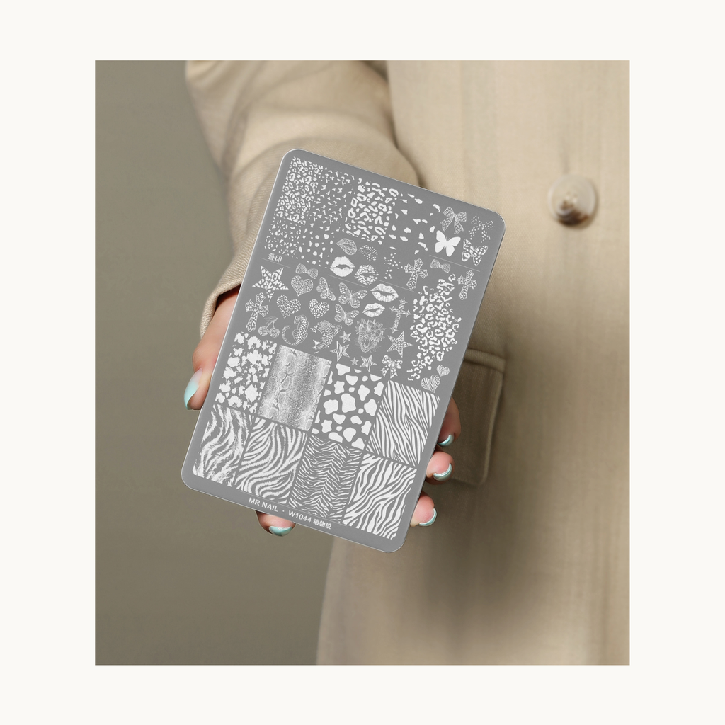 Hand holding MR NAIL W1044 animal print nail stamping plate with mixed animal textures