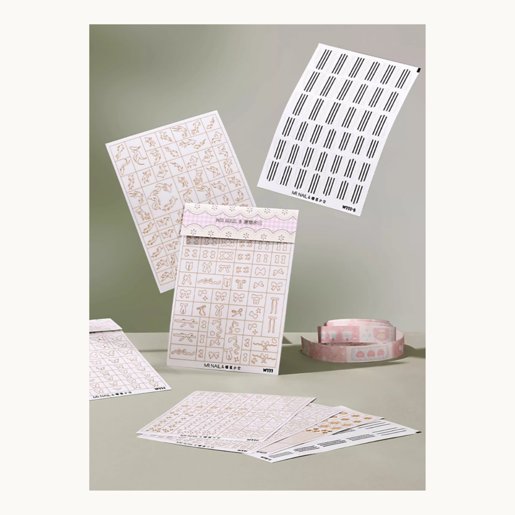 MR NAIL hollow nail art sticker collection including W343 snowflakes, bow designs and line decals displayed on a tabletop