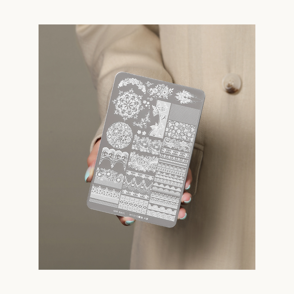 Hand holding MR NAIL W1008 lace stamping plate A version featuring intricate lace and floral nail art patterns for salon and DIY use