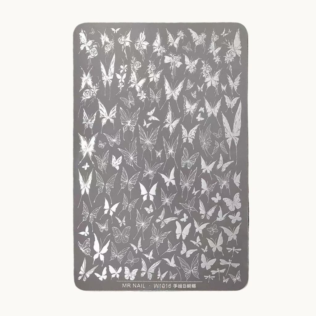 Hand holding MR NAIL W1016 butterfly nail stamping plate with detailed butterfly engraving patterns