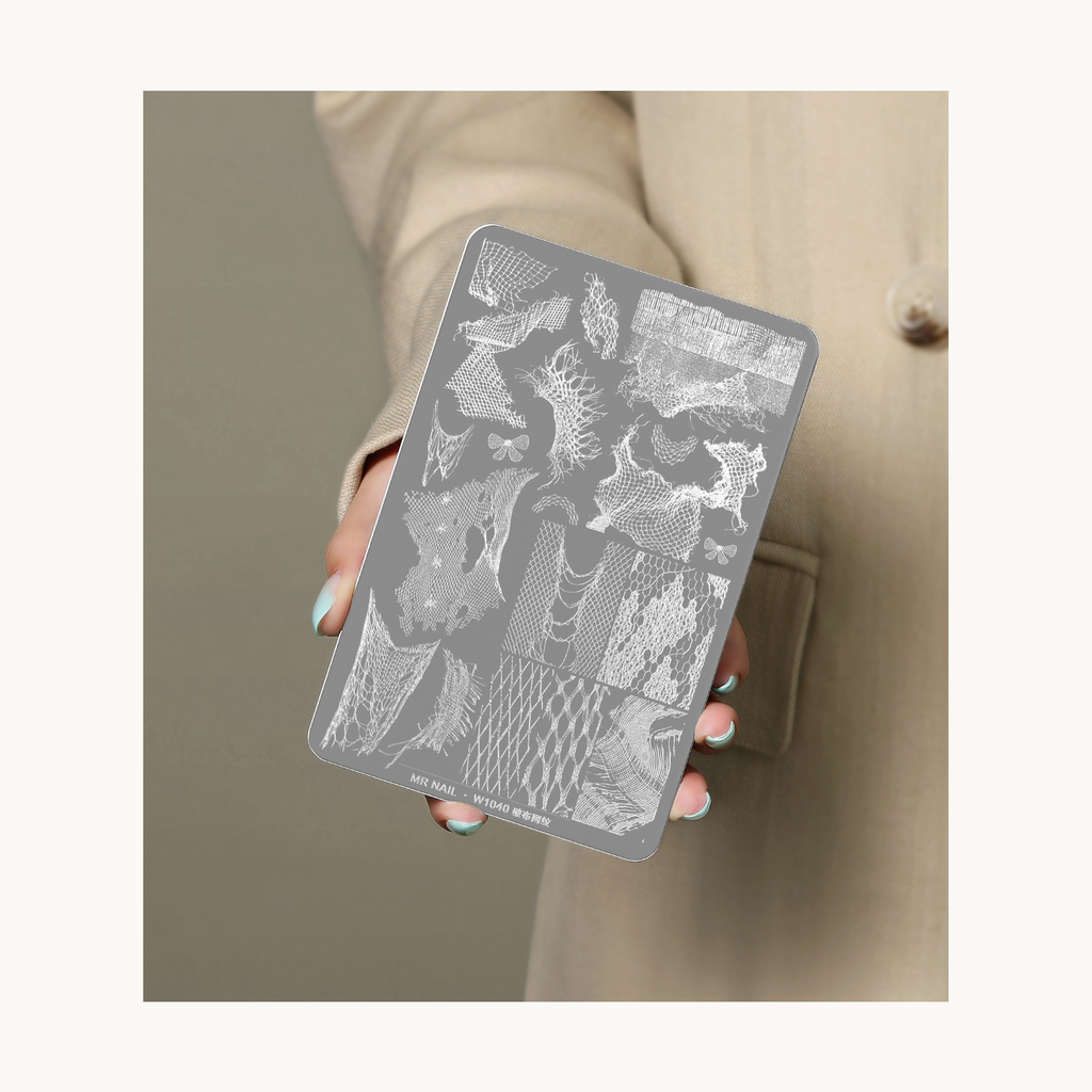 Hand holding MR NAIL W1040 distressed mesh texture nail stamping plate for size reference