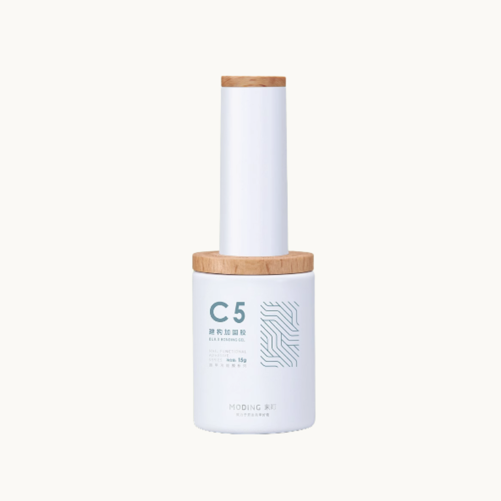 moding c05 strength builder nail gel bottle with wooden cap on white background