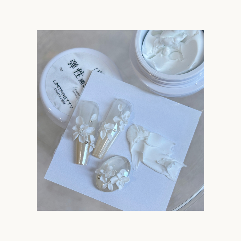 Close-up of soft white 3D bouquet-style flowers sculpted with elastic carving gel.