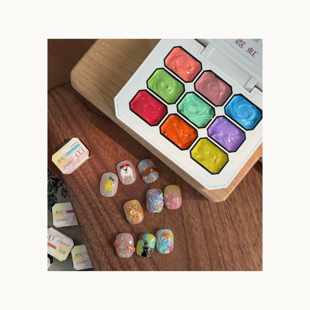 QINGYOU Cube neon gel palette with hand-painted nail art designs including animals, fruits, and colorful illustrations.
