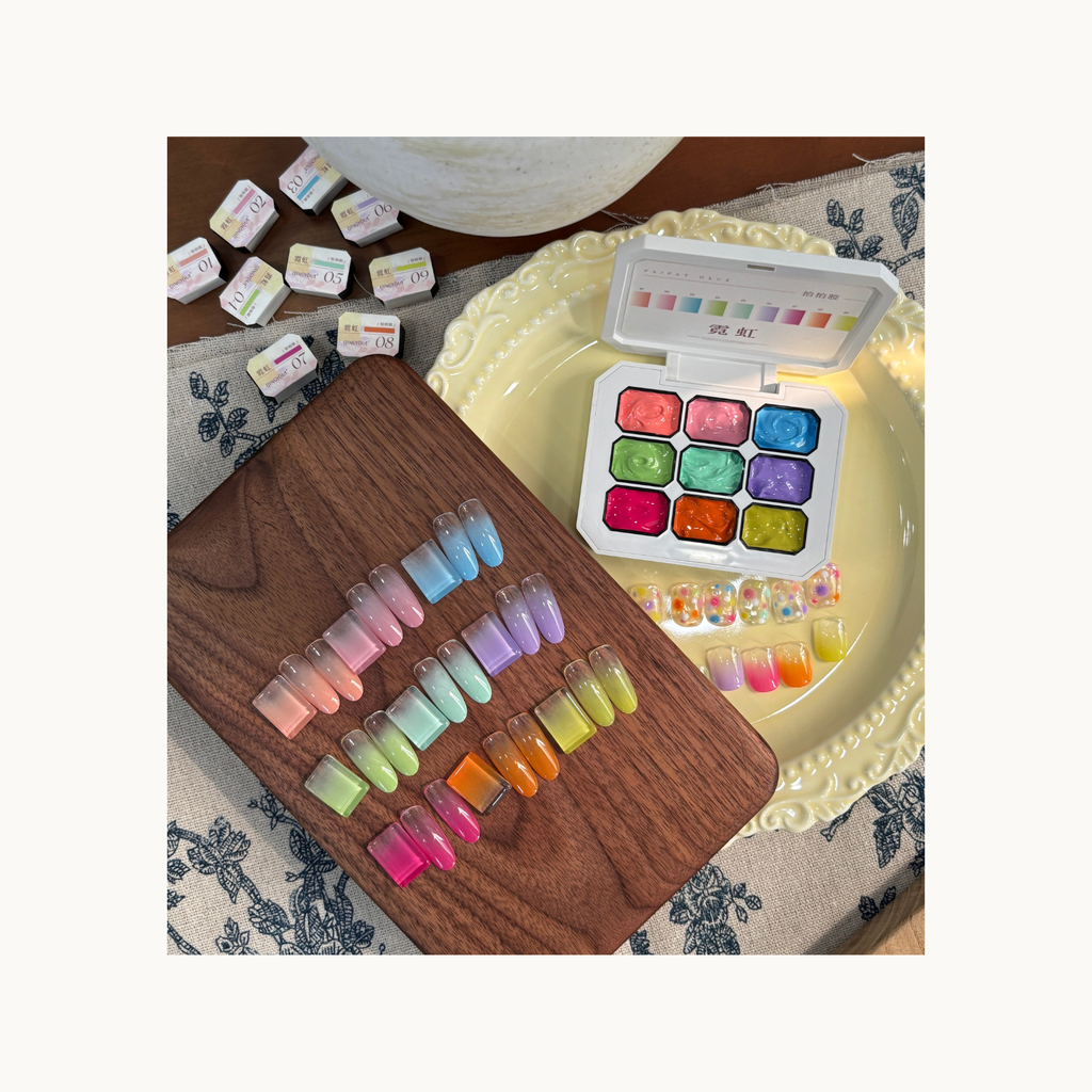 QINGYOU neon cube gel palette shown with pastel gradient press-on nails in pink, blue, purple, green, and yellow tones.