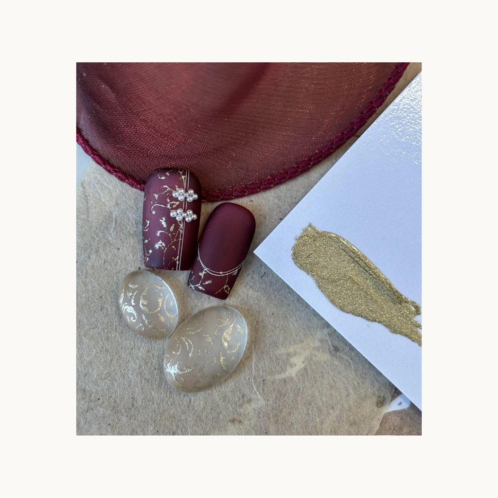 QingYou gold transfer gel used for intricate Baroque-style floral stamping on transparent nail tips.