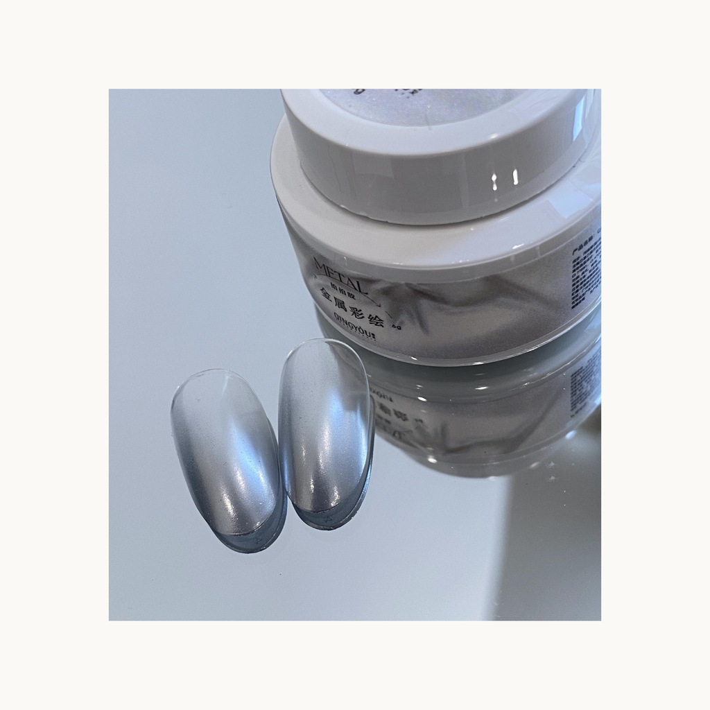 QingYou silver metal gel shown with smooth chrome nail tips on reflective background