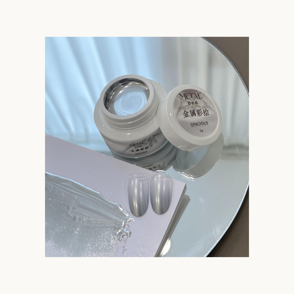 Metallic silver gel open jar with swatch smear and high-shine nail tips