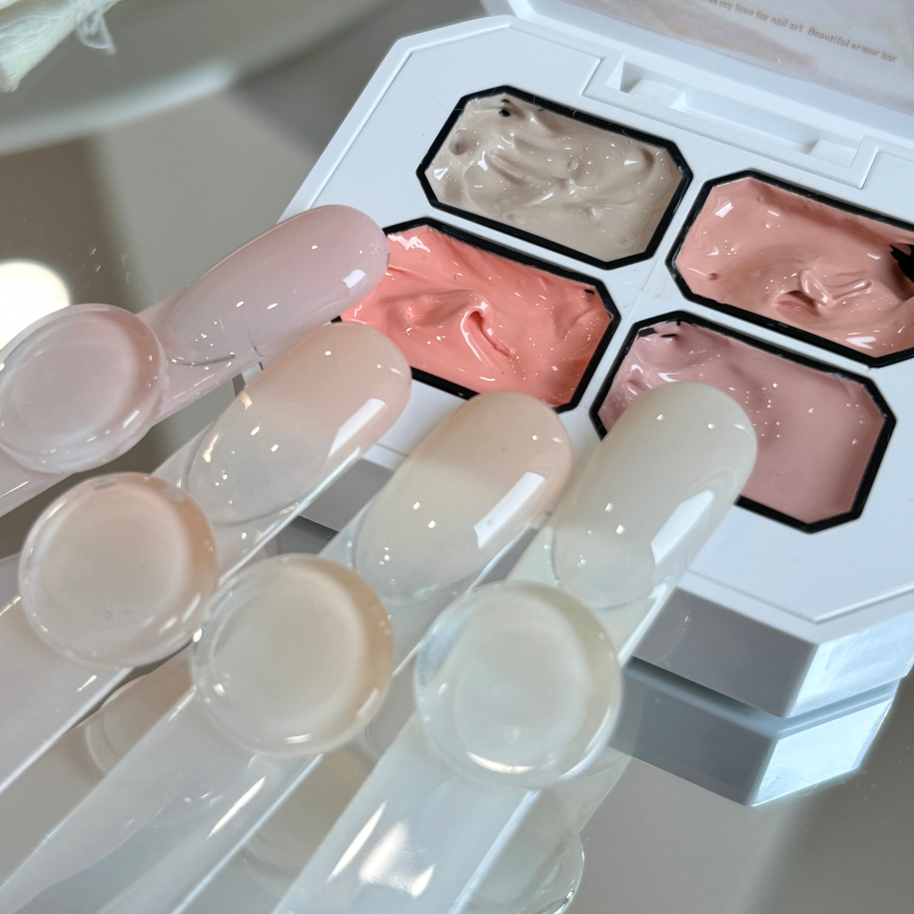 QINGYOU nude 4-grid concealer gel palette with natural nude color nail swatches on display