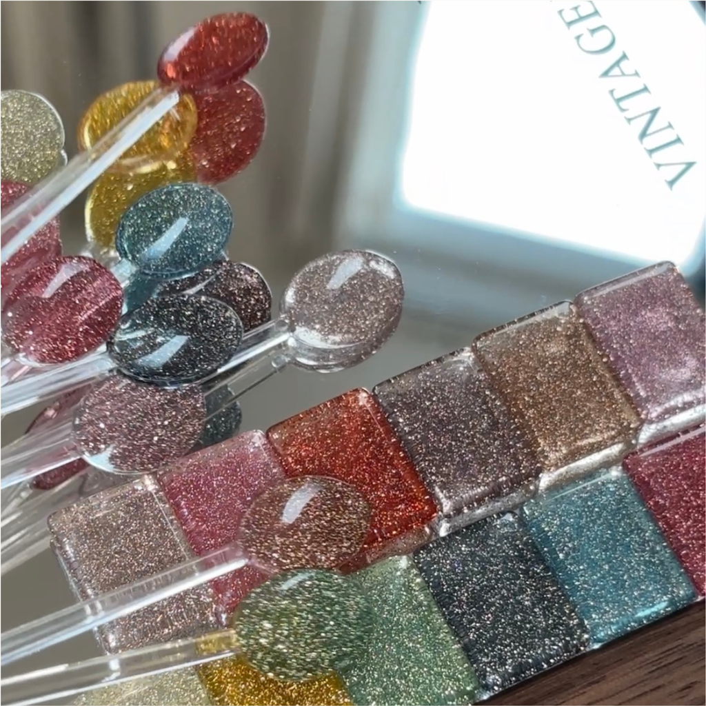 12-shade color chart displaying rainbow diamond glitter gel colors for nail art.