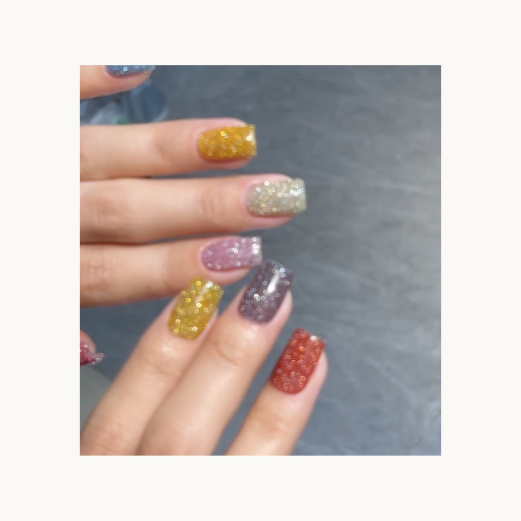 Rainbow diamond glitter gel swatch showing multi-color sparkly finish for nails.