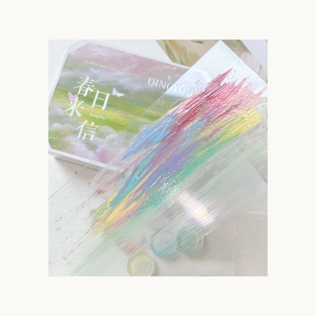 QINGYOU Spring Sun pastel gel palette showing rainbow brush stroke nail art swatches