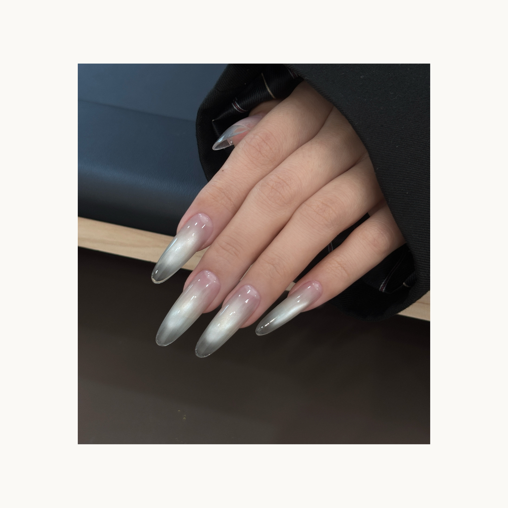 Full hand nail look using Qingyou Waterglow White Cat Eye Gel, silver glow gradient with clean cat-eye reflection.