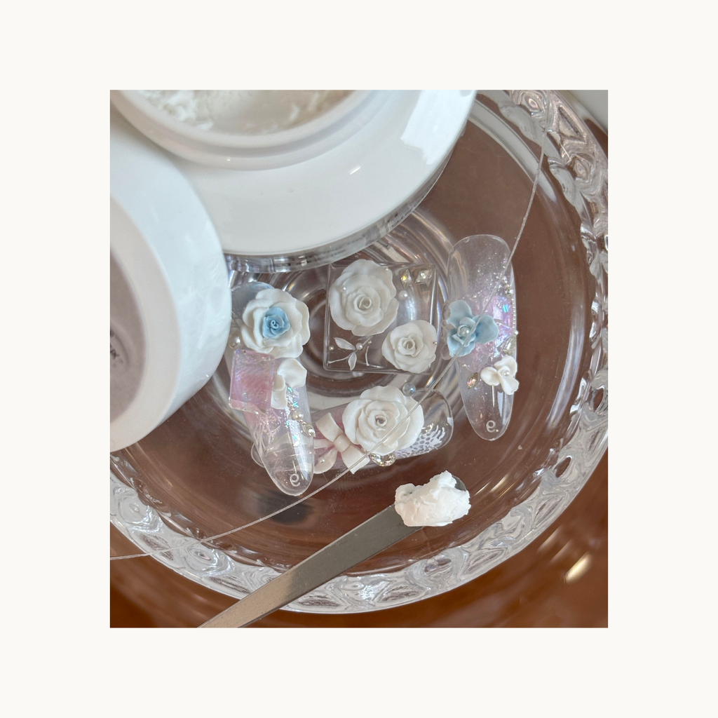 3D rose nail art pieces made with QINGYOU white carving gel shown beside the open gel jar