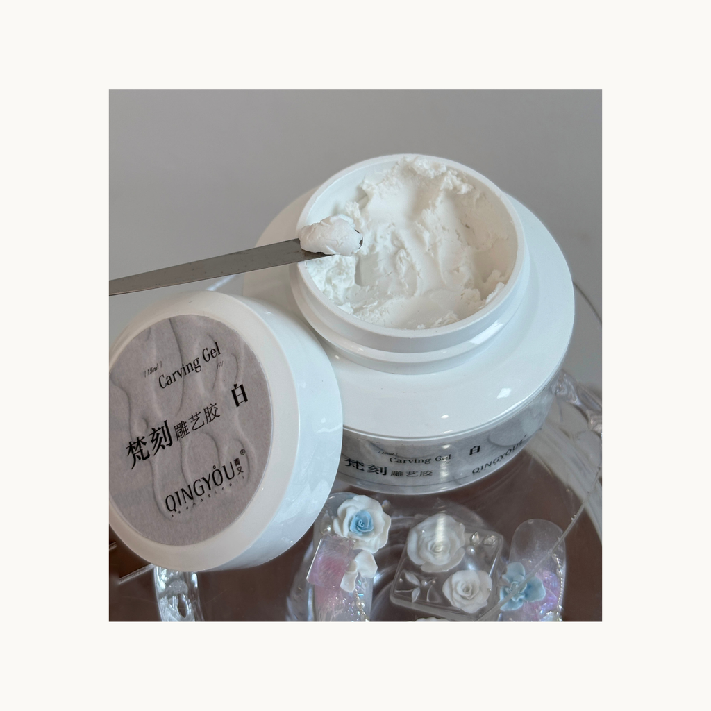 Close-up of QINGYOU white relief carving gel texture scooped with a spatula