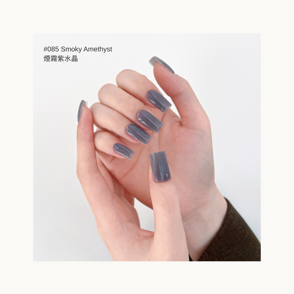 Alt text: smoky purple amethyst–tone glossy gel nail polish on medium-length square nails