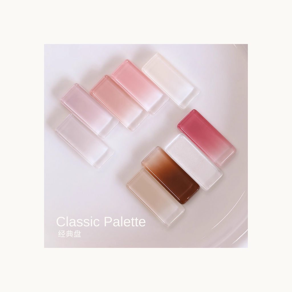Classic Palette soft nude and pink gel cube swatches arranged on a white plate for nail art color reference.