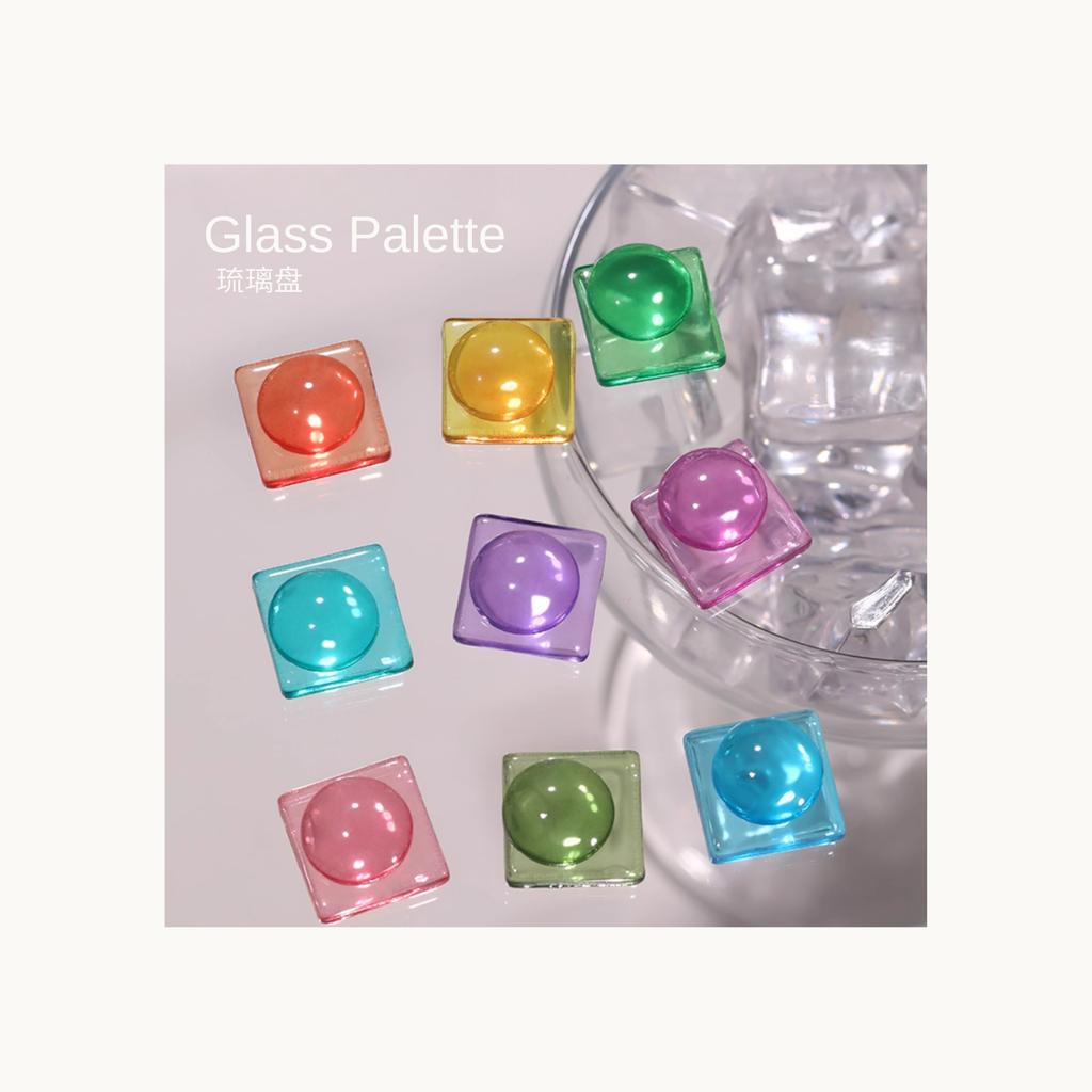 Glass Palette colorful translucent gel cubes arranged beside a glass bowl with ice for a crystal-like effect.