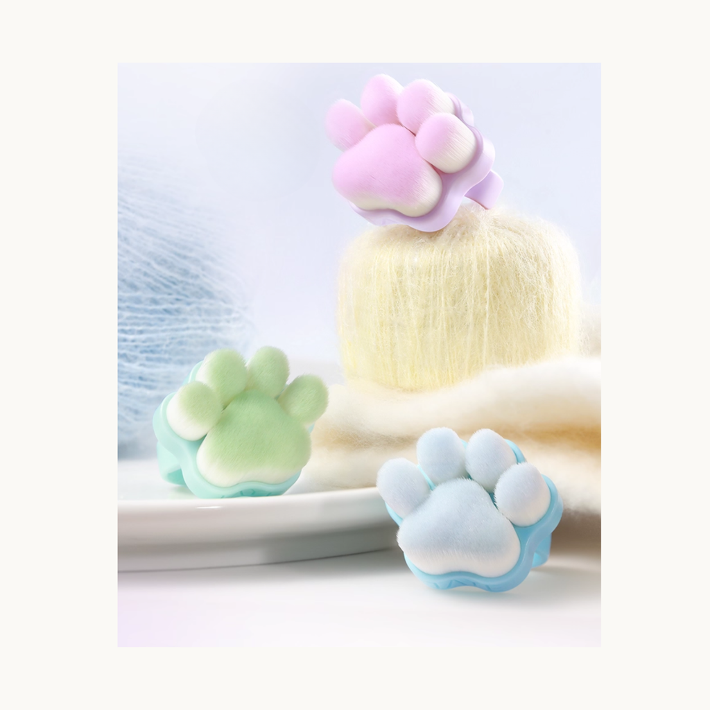 Pastel cat paw nail dust brushes in soft plush background for blind box series